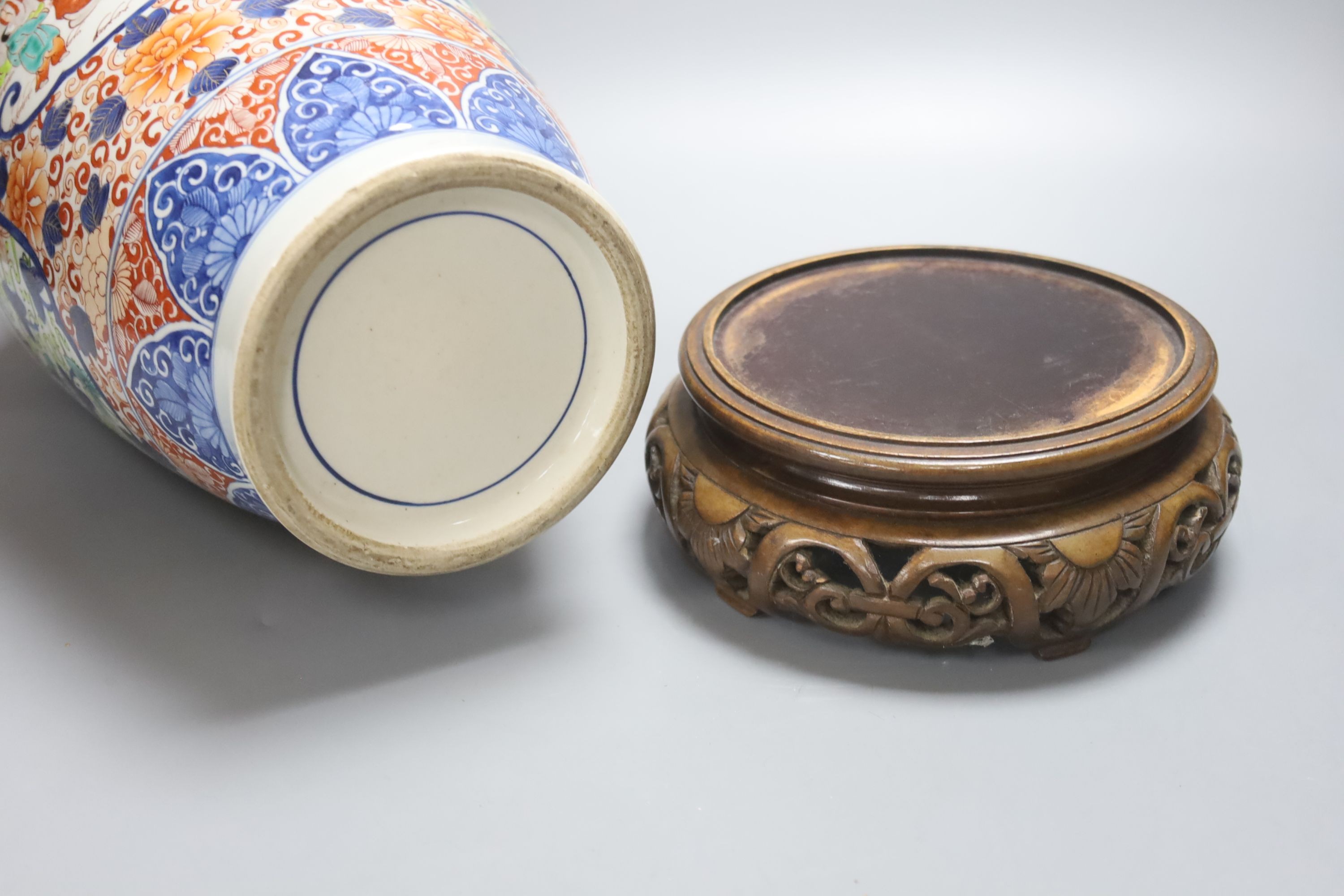 A large 20th century Japanese Arita porcelain vase, wood stand, restored 50cm